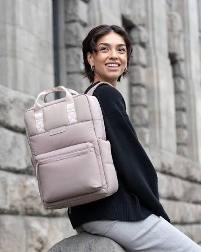 A Kapten & Son customer carrying the brand's backpack.