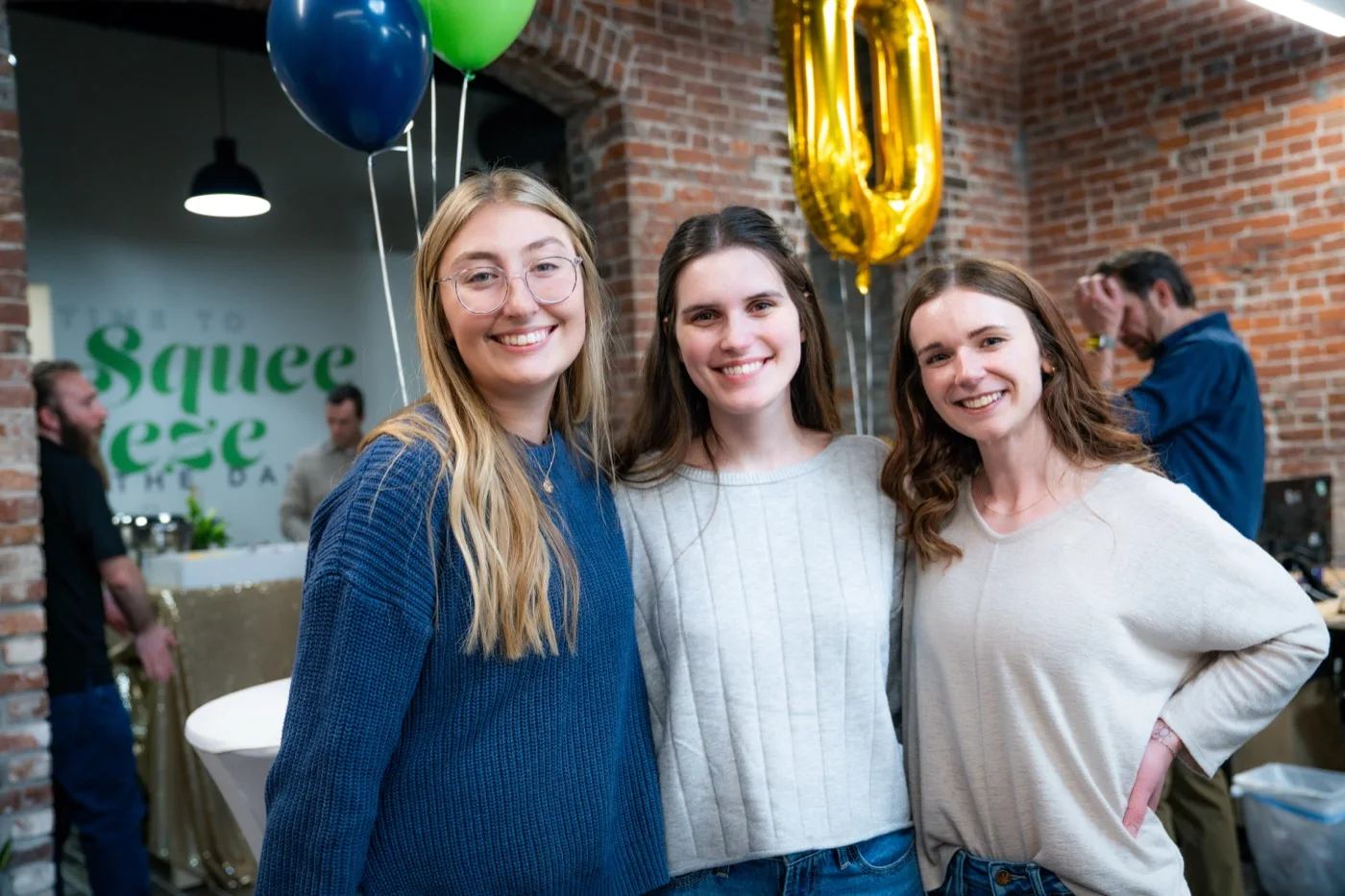 Three LimeLight teammates smiling together at a celebration