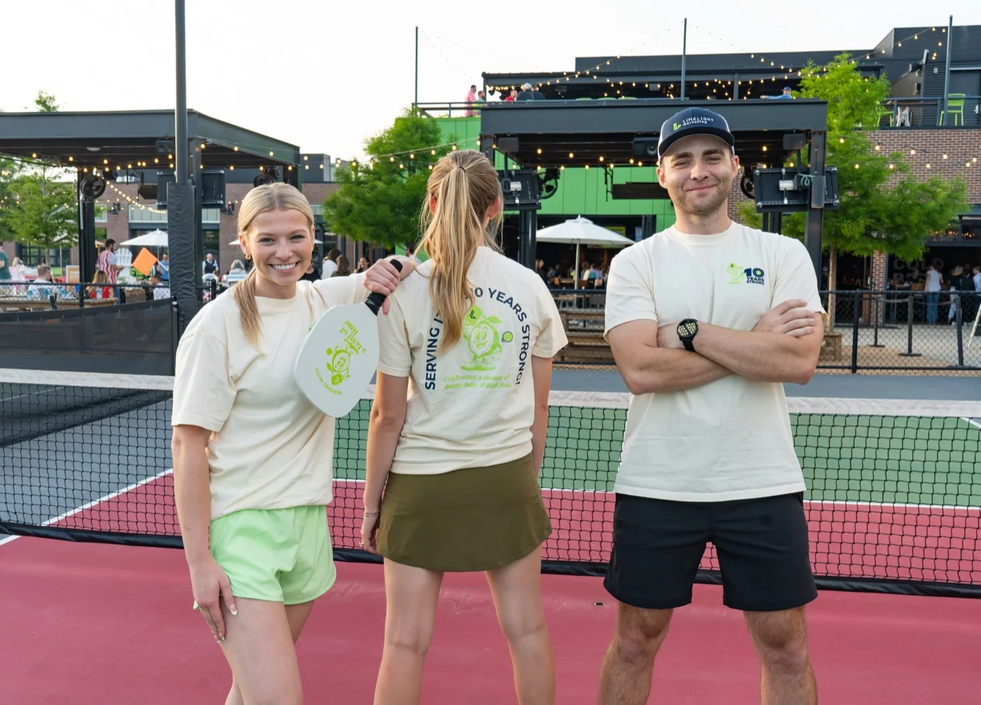 Three LimeLight teammates at a pickleball court