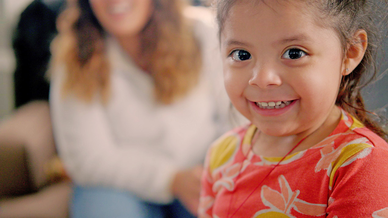 Little girl smiling, from the Catholic Charities homepage banner
